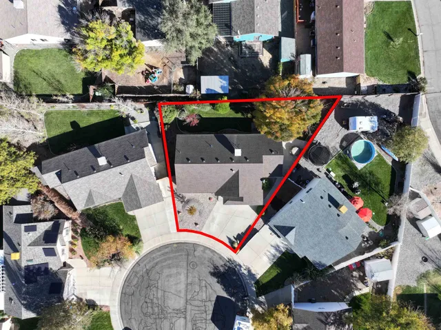 an aerial view of a house with a yard and lake view