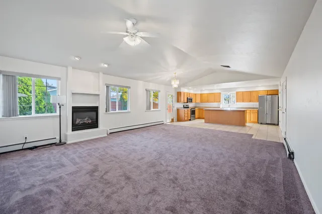 a view of empty room with a fireplace and window