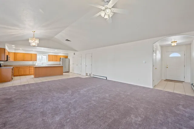 an empty room with closet and windows
