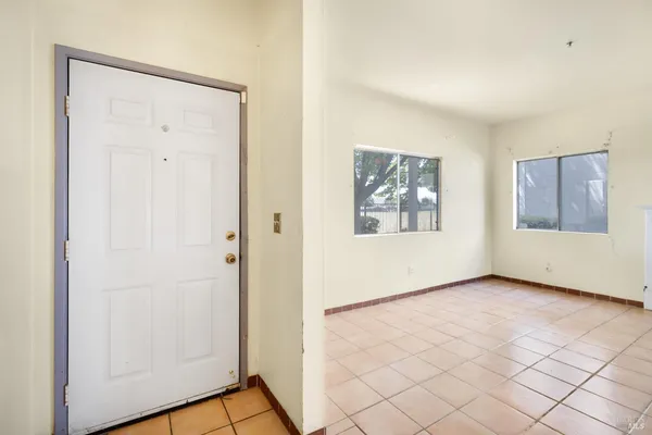 an empty room with windows and closet