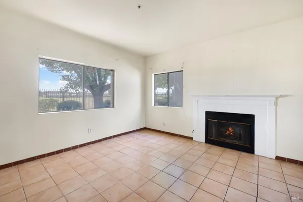 a view of an empty room and fire place