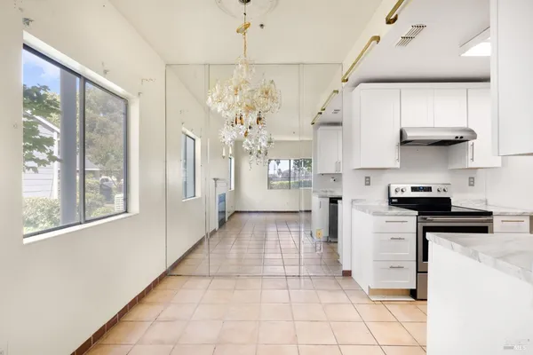 a kitchen with stainless steel appliances granite countertop a refrigerator and a stove top oven