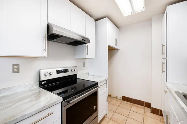 a kitchen with stainless steel appliances a stove and a refrigerator