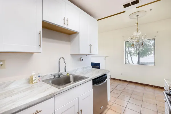 a kitchen with a sink a stove and cabinets