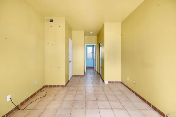 a view of a hallway with a bathroom