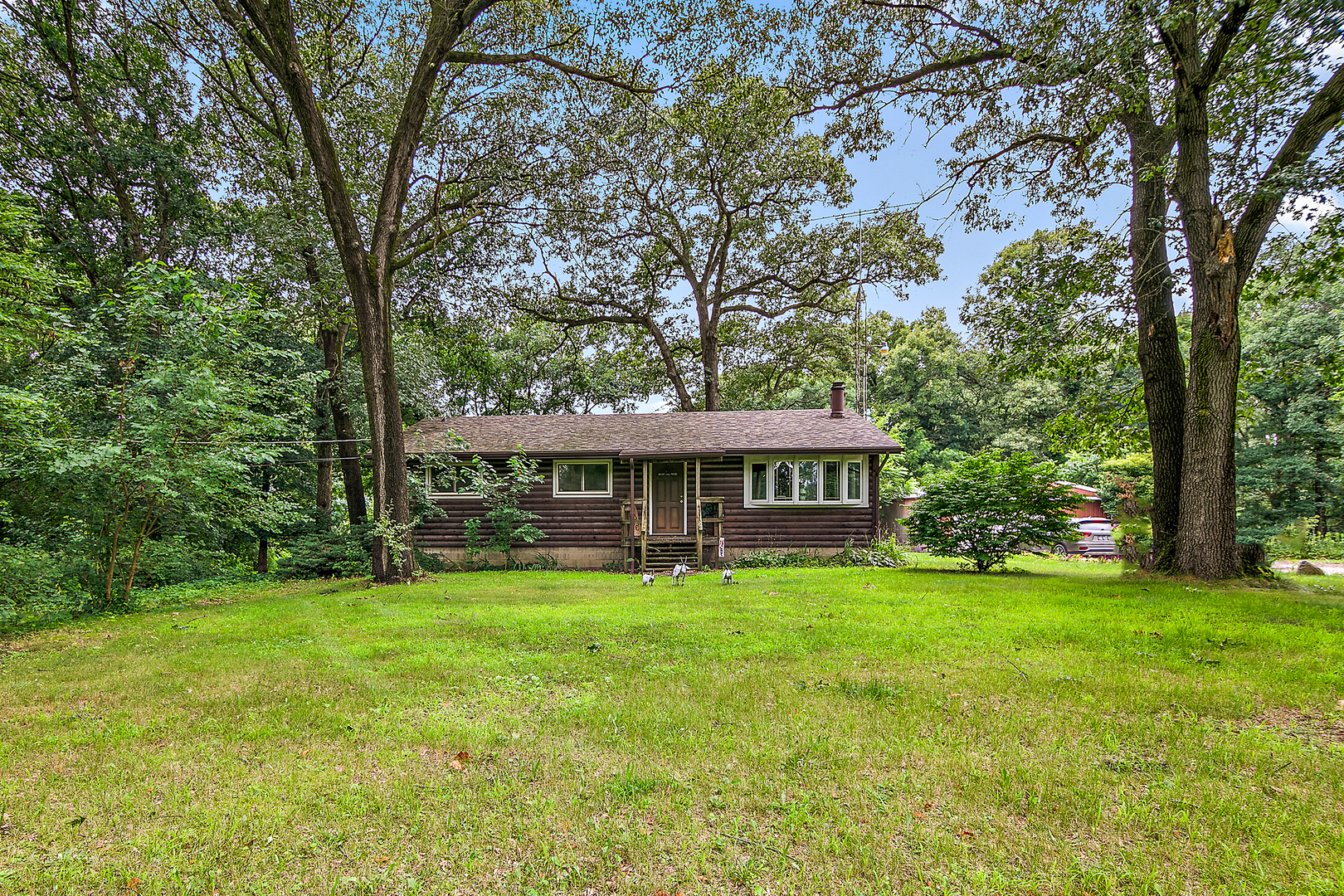 418 South 5000W Road Kankakee, IL 60901 - Photo 1 of 38 a view of a house with a big yard and large trees