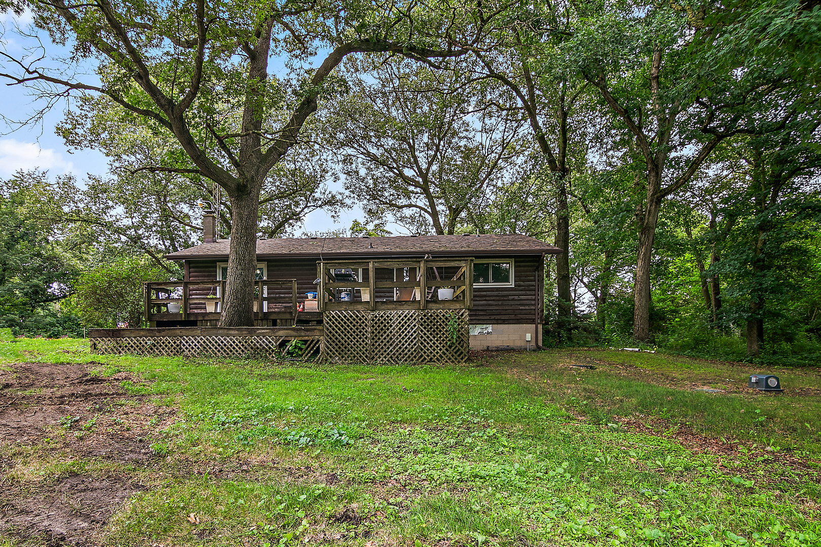 418 South 5000W Road Kankakee, IL 60901 - Photo 18 of 38 a view of house in front of a big yard with large trees
