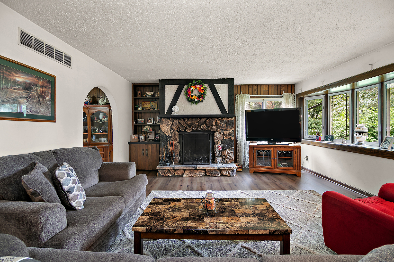 418 South 5000W Road Kankakee, IL 60901 - Photo 3 of 38 a living room with furniture a large window and a flat screen tv
