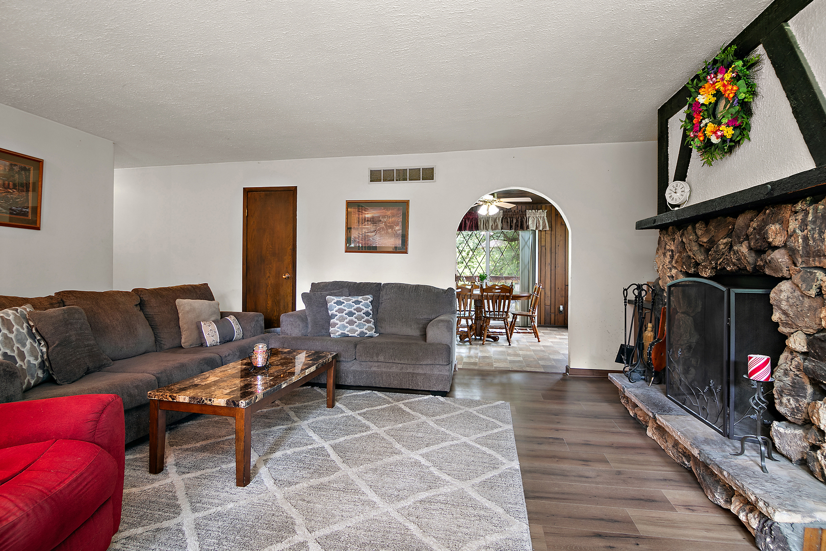 418 South 5000W Road Kankakee, IL 60901 - Photo 5 of 38 a living room with furniture a flat screen tv and a fireplace