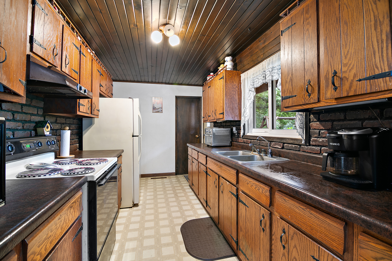 418 South 5000W Road Kankakee, IL 60901 - Photo 8 of 38 a kitchen with stainless steel appliances granite countertop a sink a stove and a refrigerator