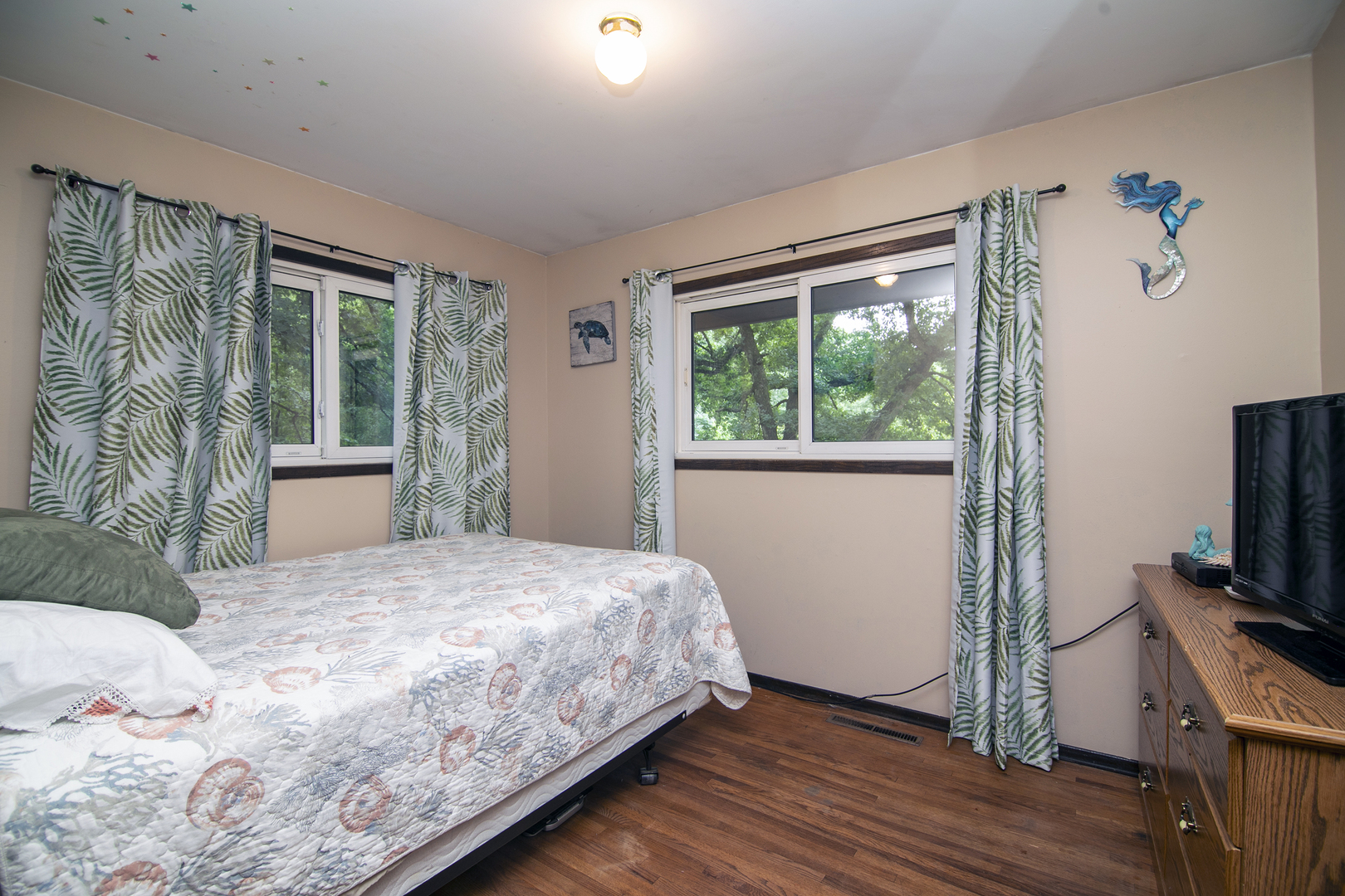 418 South 5000W Road Kankakee, IL 60901 - Photo 10 of 38 a bedroom with a bed and a flat tv screen on dresser