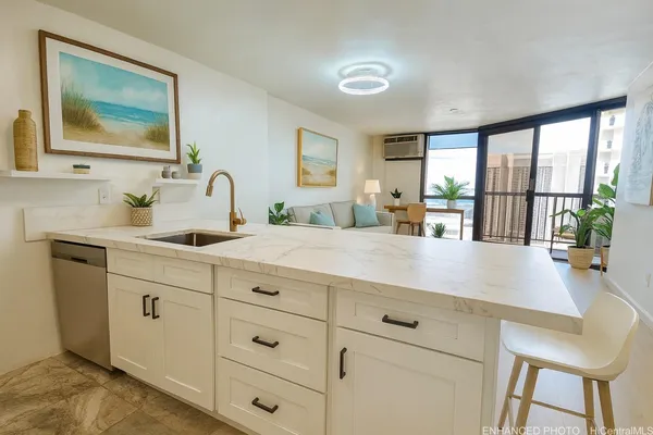 a kitchen with sink and large window