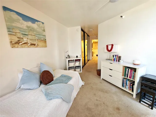 a bedroom with furniture and a book shelf