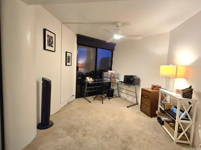 a living room with furniture and a lamp