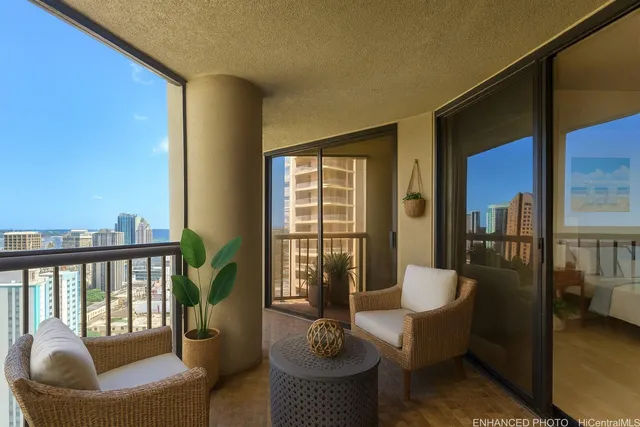 a balcony with furniture and a potted plant