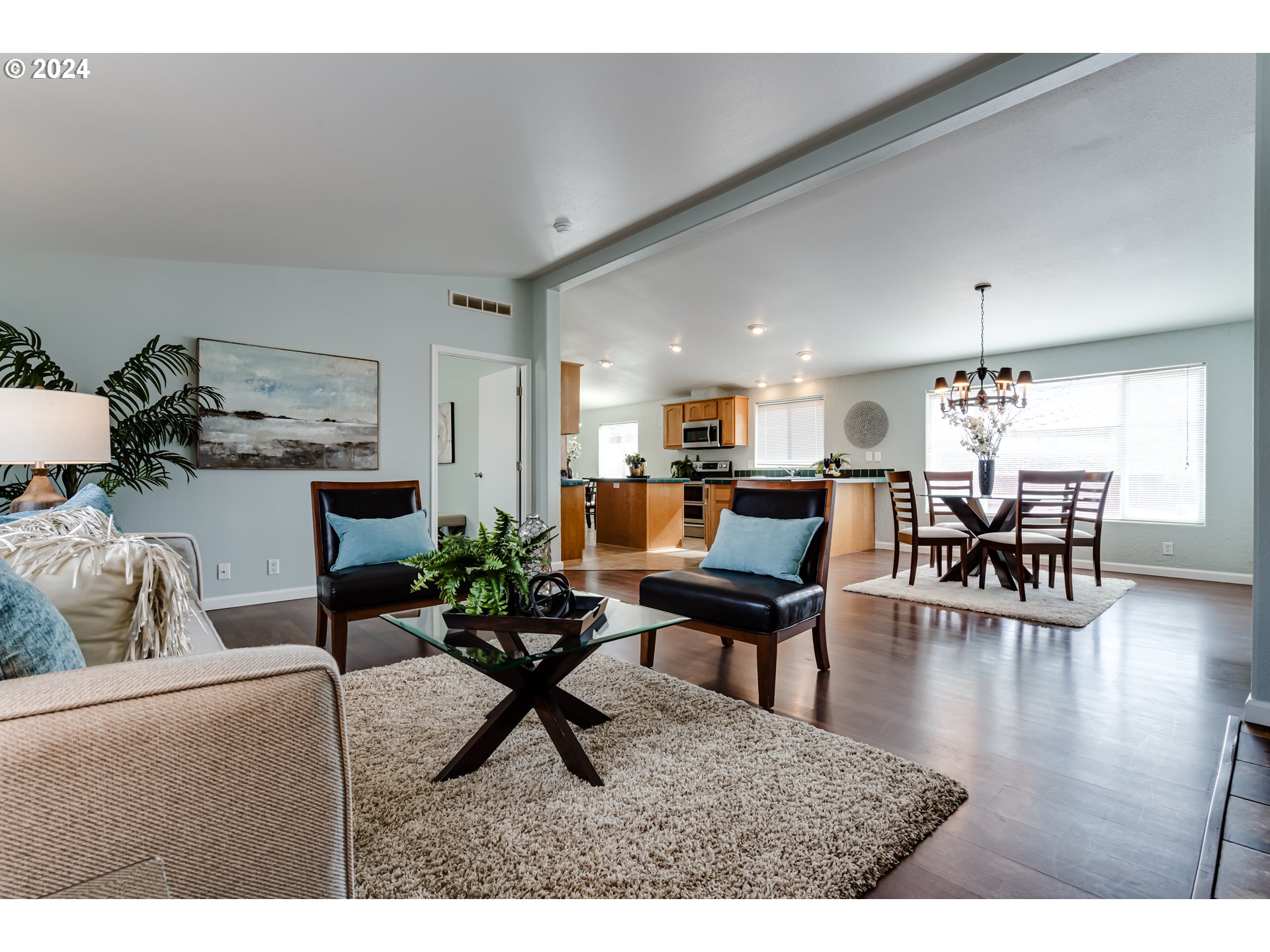 2533 Maia Loop Springfield, OR 97477 - Photo 2 of 28 a living room with furniture and a dining table with wooden floor