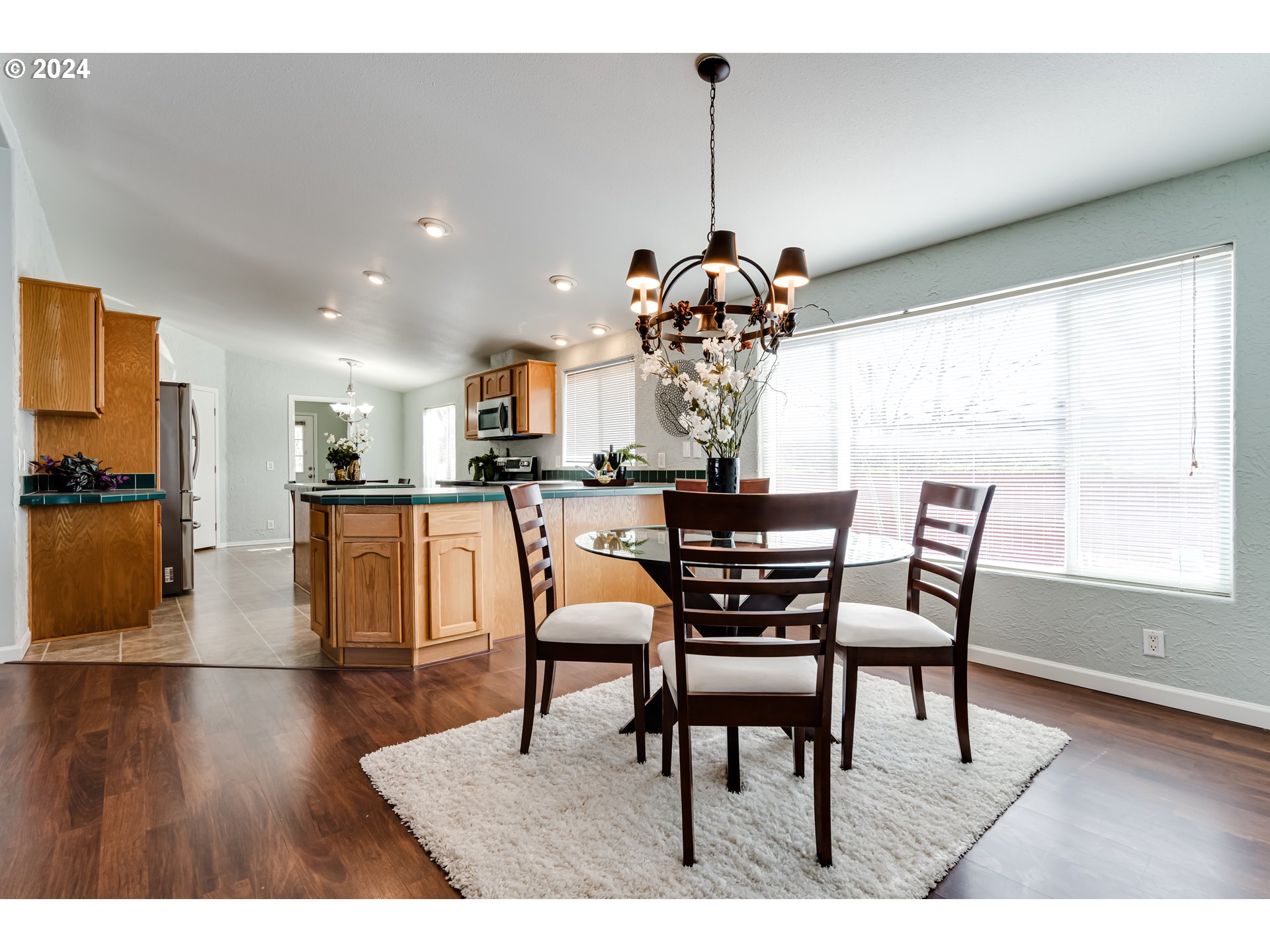 2533 Maia Loop Springfield, OR 97477 - Photo 4 of 28 a view of a dining room and livingroom with furniture wooden floor a chandelier