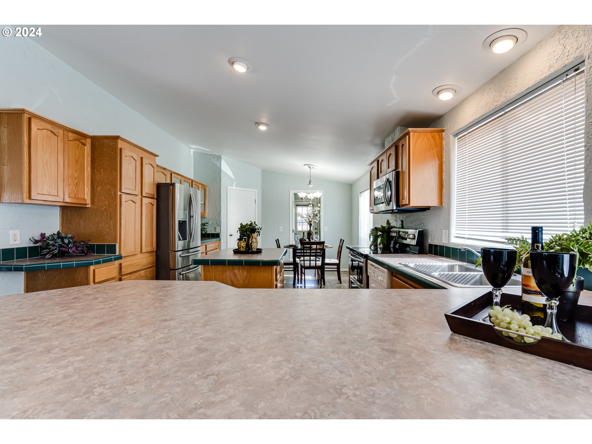 2533 Maia Loop Springfield, OR 97477 - Photo 7 of 28 a view of kitchen with stainless steel appliances granite countertop a sink counter top space and living room view