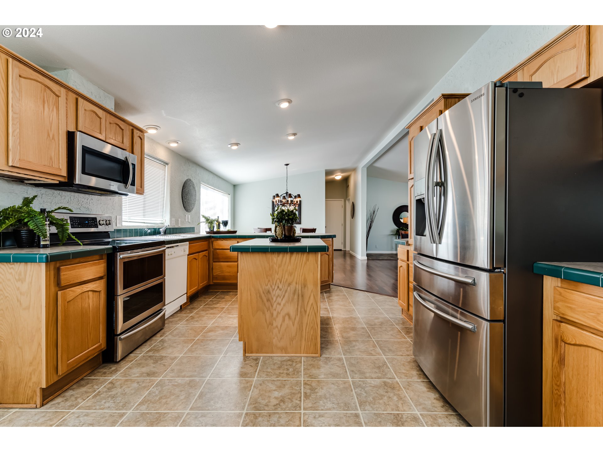 2533 Maia Loop Springfield, OR 97477 - Photo 9 of 28 a kitchen with stainless steel appliances granite countertop a refrigerator a stove top oven a sink and dishwasher
