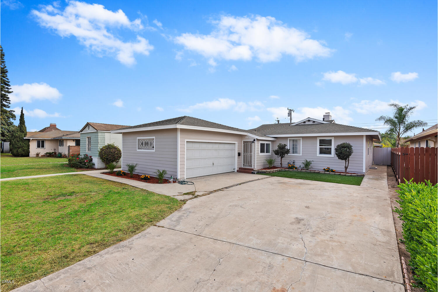 1034 West Roderick Avenue Oxnard, CA 93030 - Photo 1 of 20 a front view of a house with a yard and garage