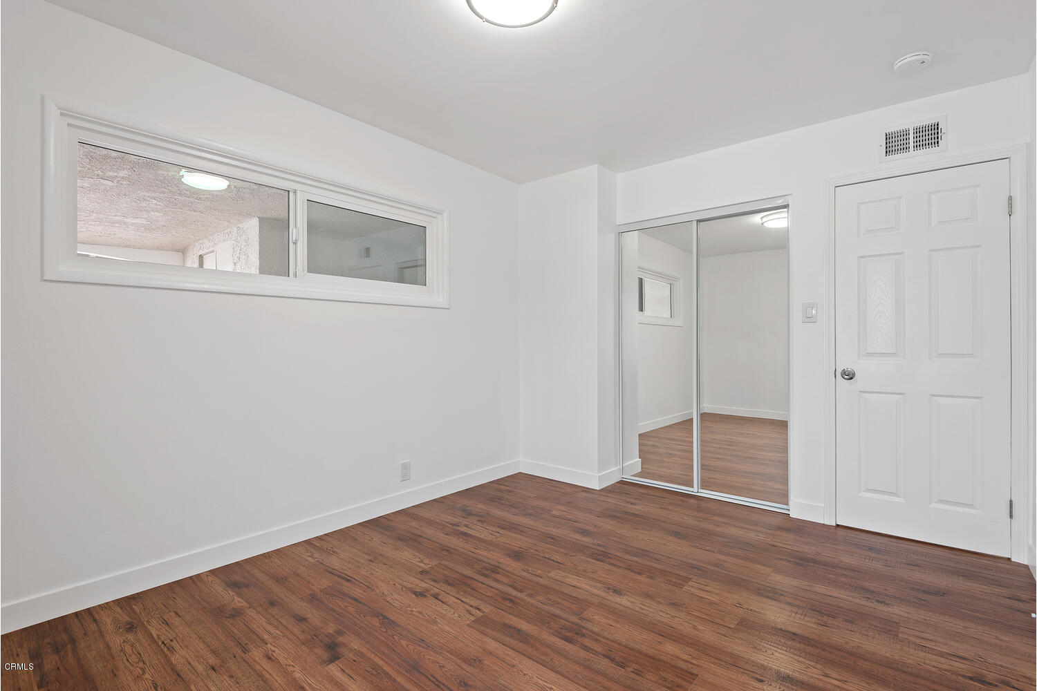 1034 West Roderick Avenue Oxnard, CA 93030 - Photo 13 of 20 a view of empty room with wooden floor and fan