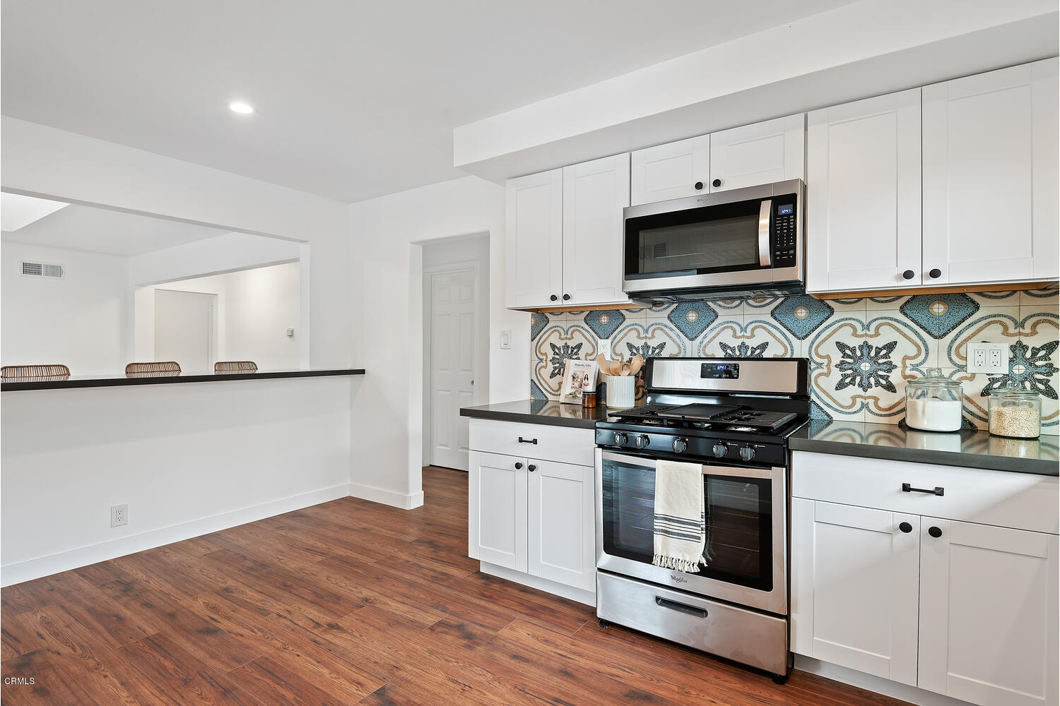 1034 West Roderick Avenue Oxnard, CA 93030 - Photo 9 of 20 a kitchen with stainless steel appliances white cabinets and a stove top oven