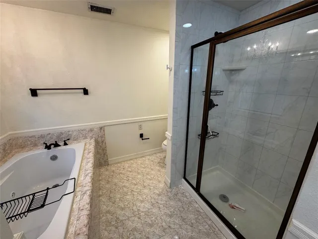 a bathroom with a shower a toilet and a shower