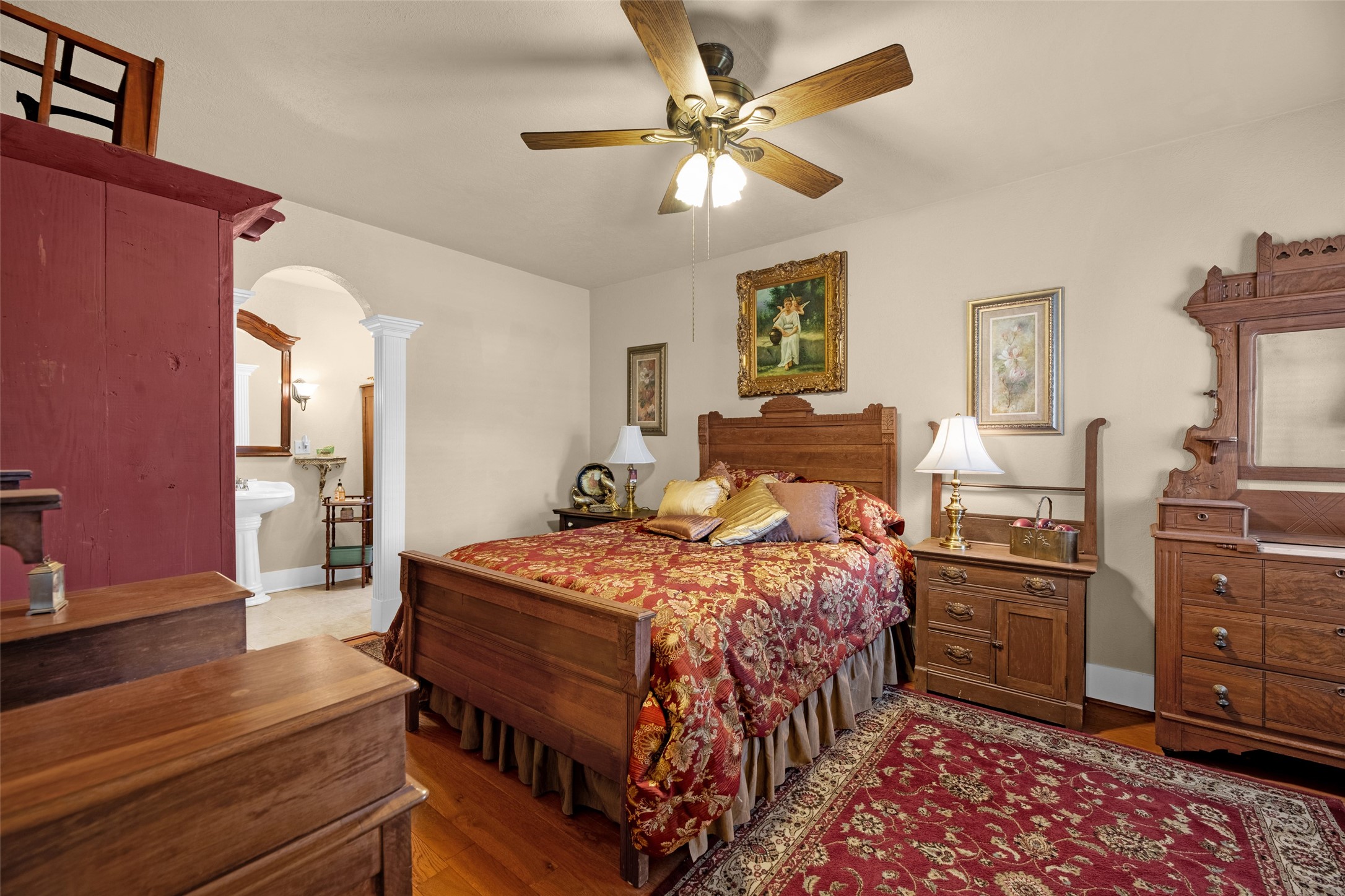 801 North Fulton Street Wharton, TX 77488 - Photo 14 of 43 This first guest bedroom is off to the right of the family room. It features beautiful hardwood floors, a ceiling fan, and an arched doorway to en suite bath