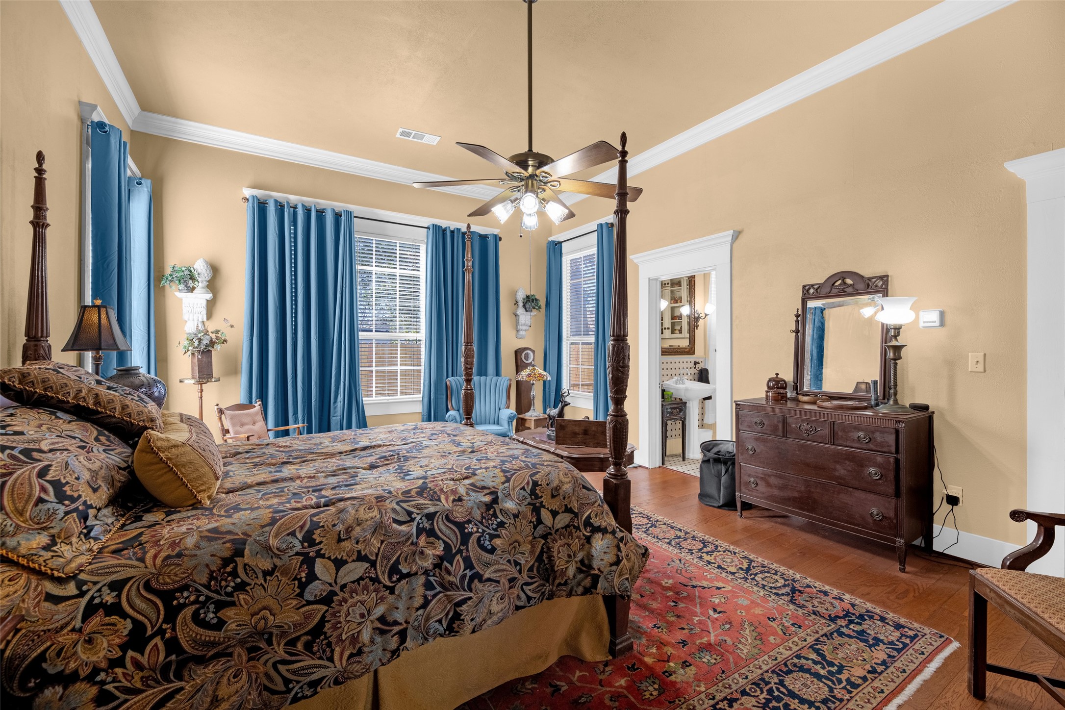 801 North Fulton Street Wharton, TX 77488 - Photo 19 of 43 a bedroom with a bed a chandelier and dresser