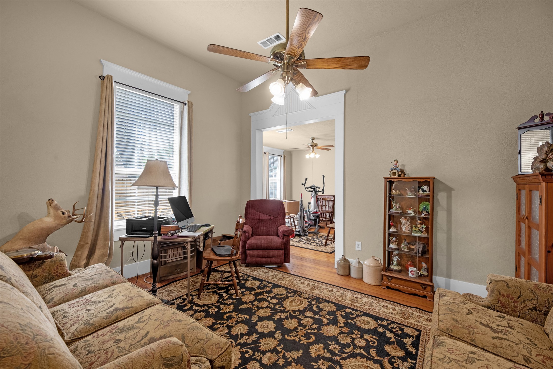 801 North Fulton Street Wharton, TX 77488 - Photo 23 of 43 Here's the sitting area/office which leads to the 3rd bedroom which also has an ensuite. The awesome aspect of this suite is that there's a doorway from the bedroom that leads to a private side yard deck and garden area. It's a peaceful retreat with a fountain that draws you in to relax the cares of the day away --- or start your day with your coffee and a bit of quiet time.