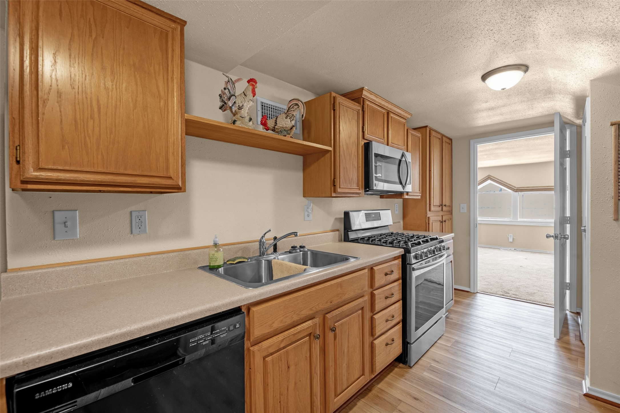 801 North Fulton Street Wharton, TX 77488 - Photo 35 of 43 a kitchen with stainless steel appliances a sink stove and cabinets