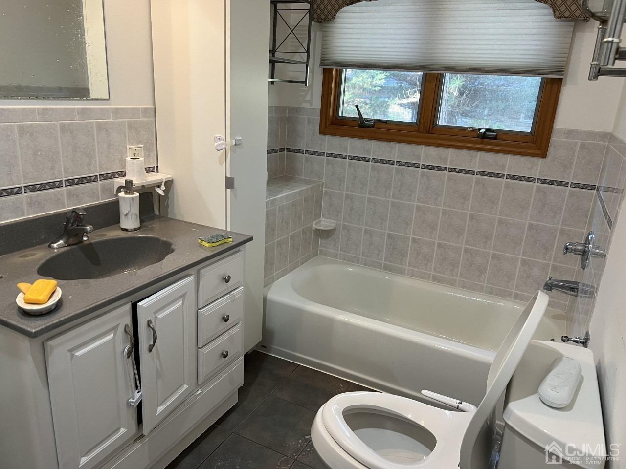60 Utica Road Edison, NJ 08820 - Photo 15 of 38 a bathroom with a sink a toilet and bathtub