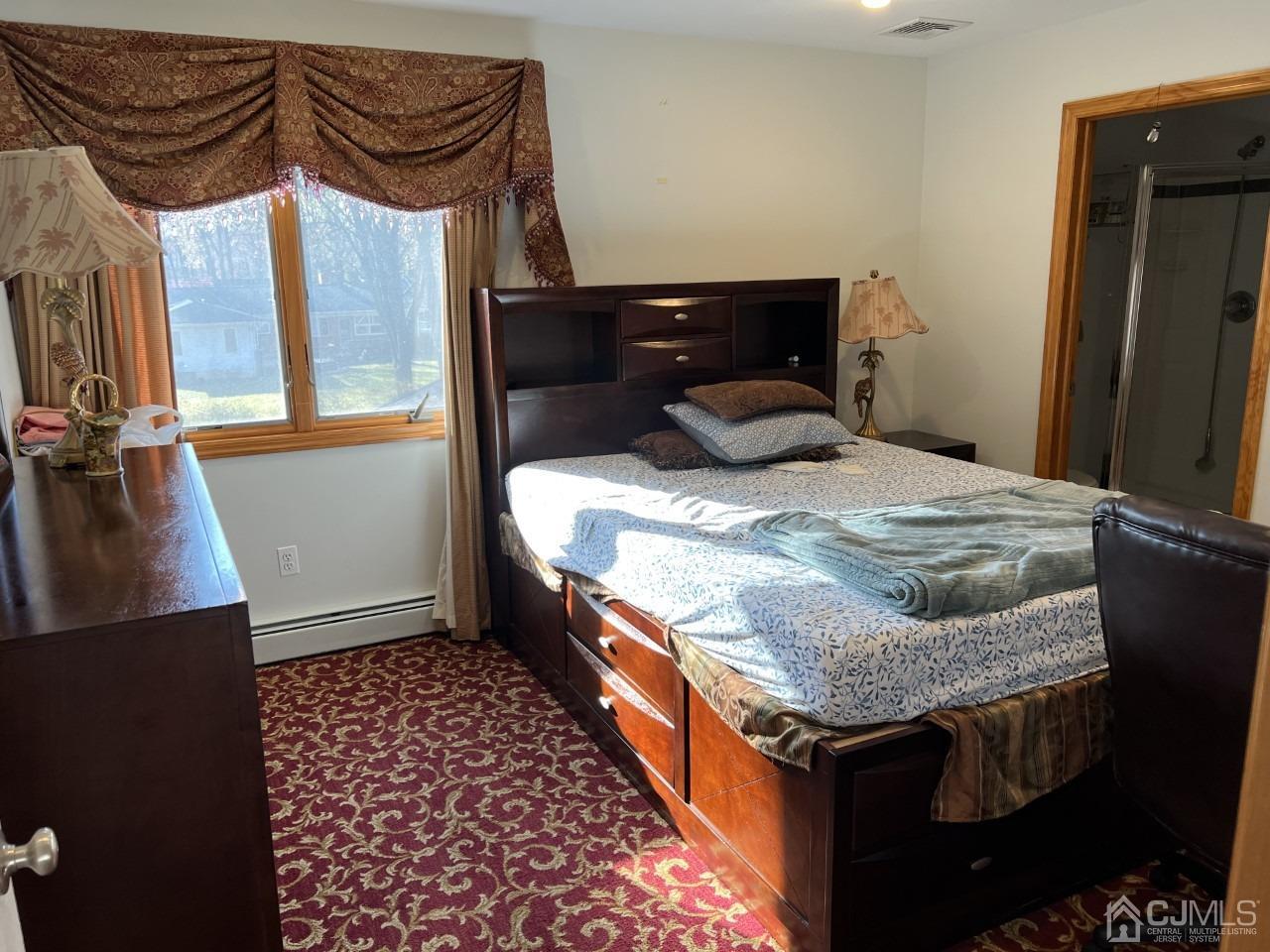 60 Utica Road Edison, NJ 08820 - Photo 22 of 38 a bed in a bedroom next to a window