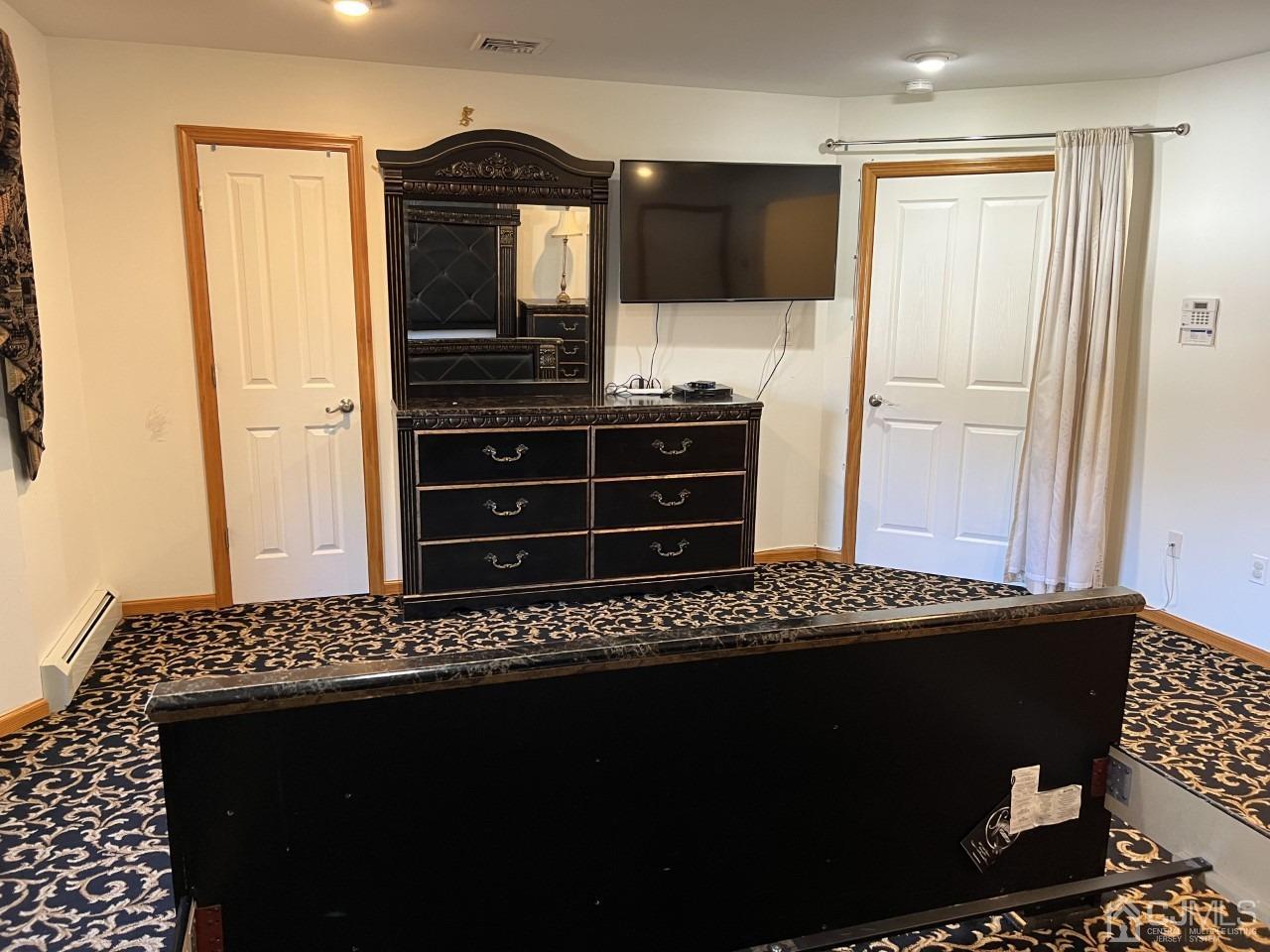 60 Utica Road Edison, NJ 08820 - Photo 23 of 38 a living room with a flat screen tv and dresser