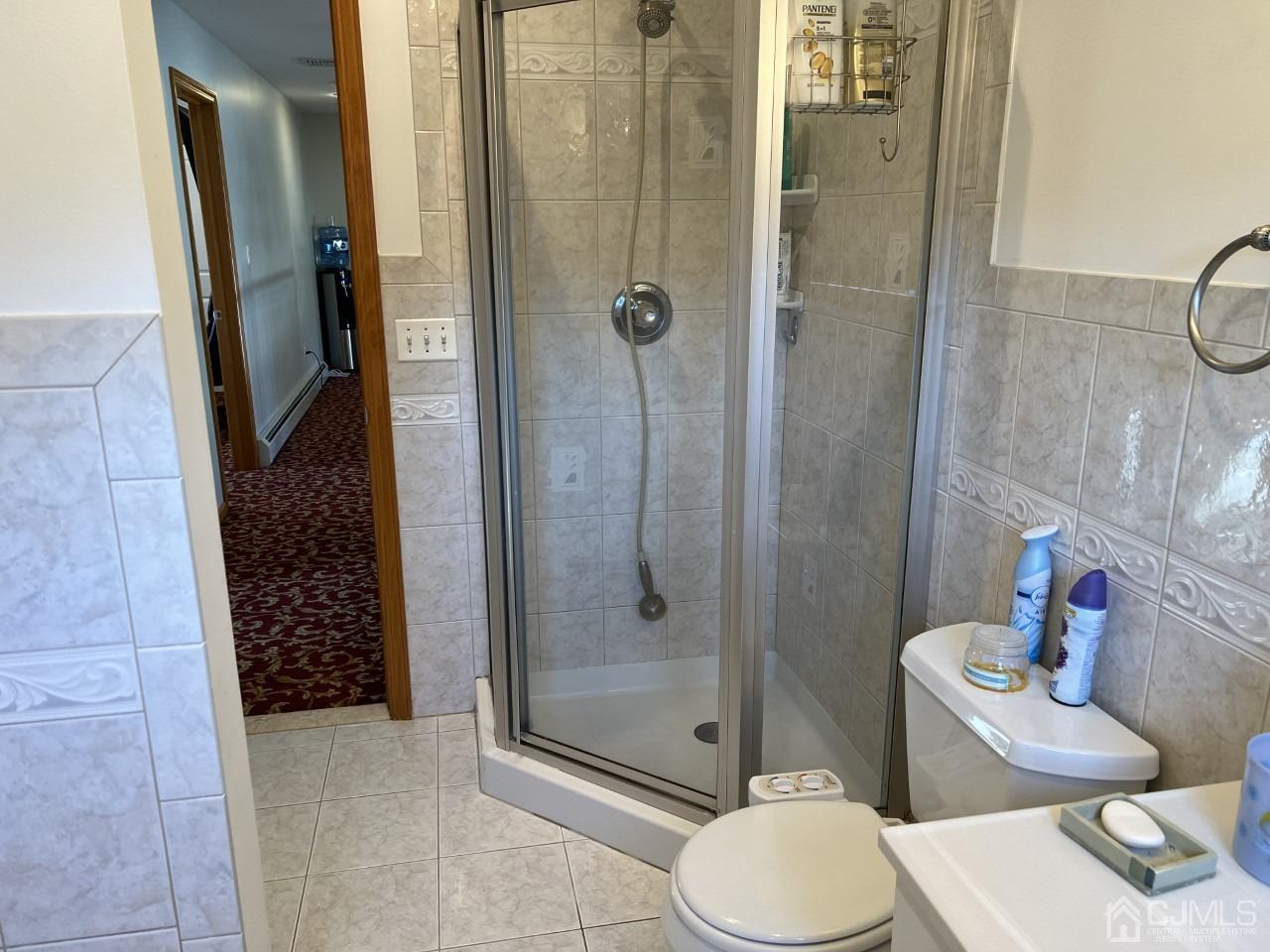 60 Utica Road Edison, NJ 08820 - Photo 26 of 38 a bathroom with a granite countertop toilet a sink and shower