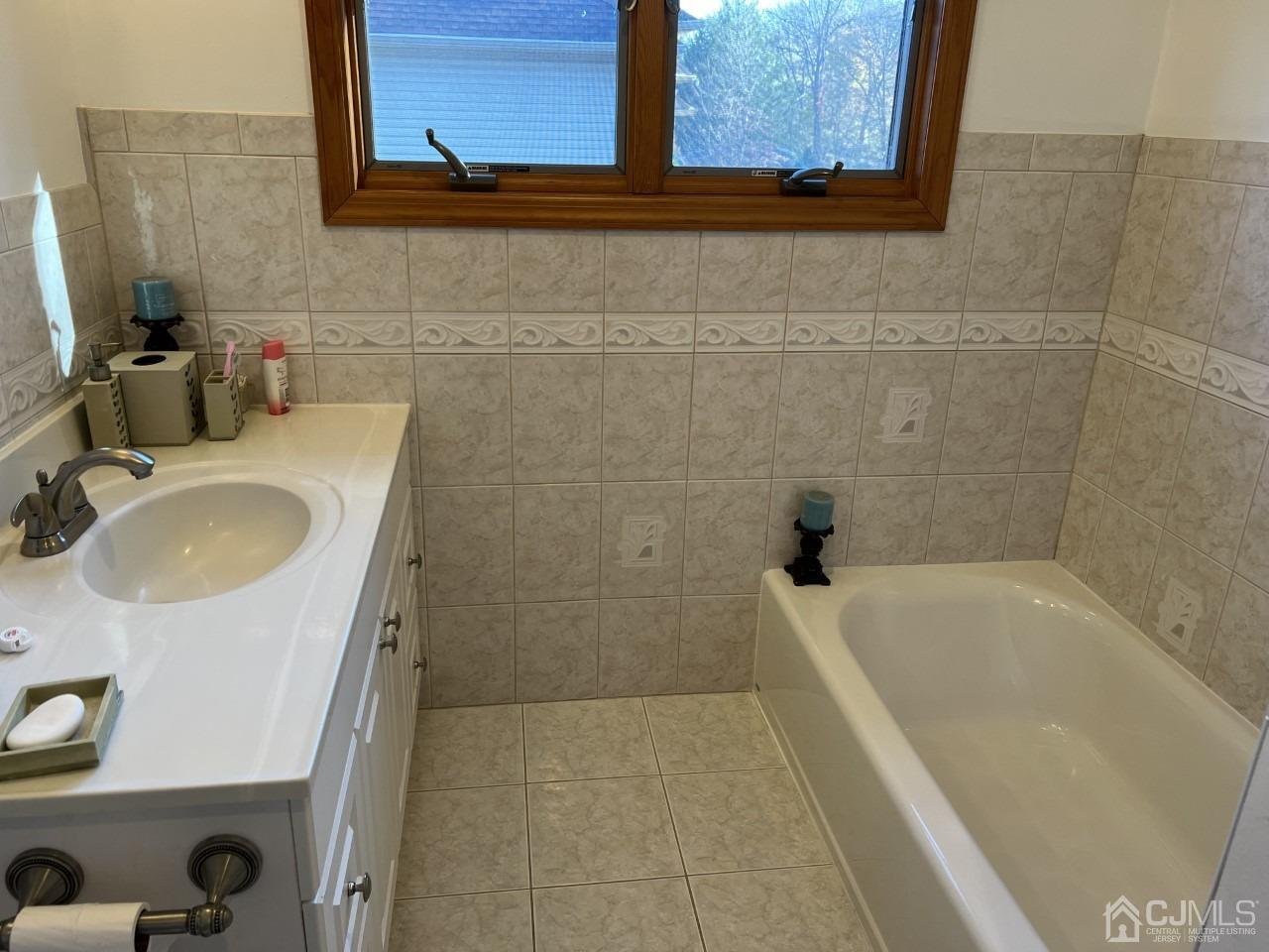 60 Utica Road Edison, NJ 08820 - Photo 27 of 38 a bathroom with a tub sink and mirror