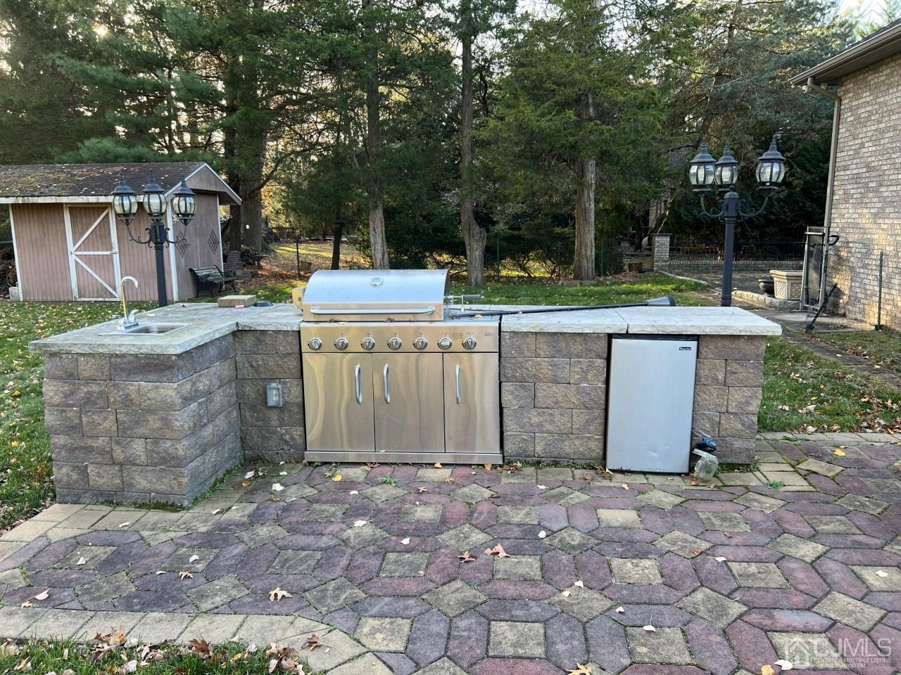 60 Utica Road Edison, NJ 08820 - Photo 34 of 38 a view of a backyard with table and chairs and a barbeque