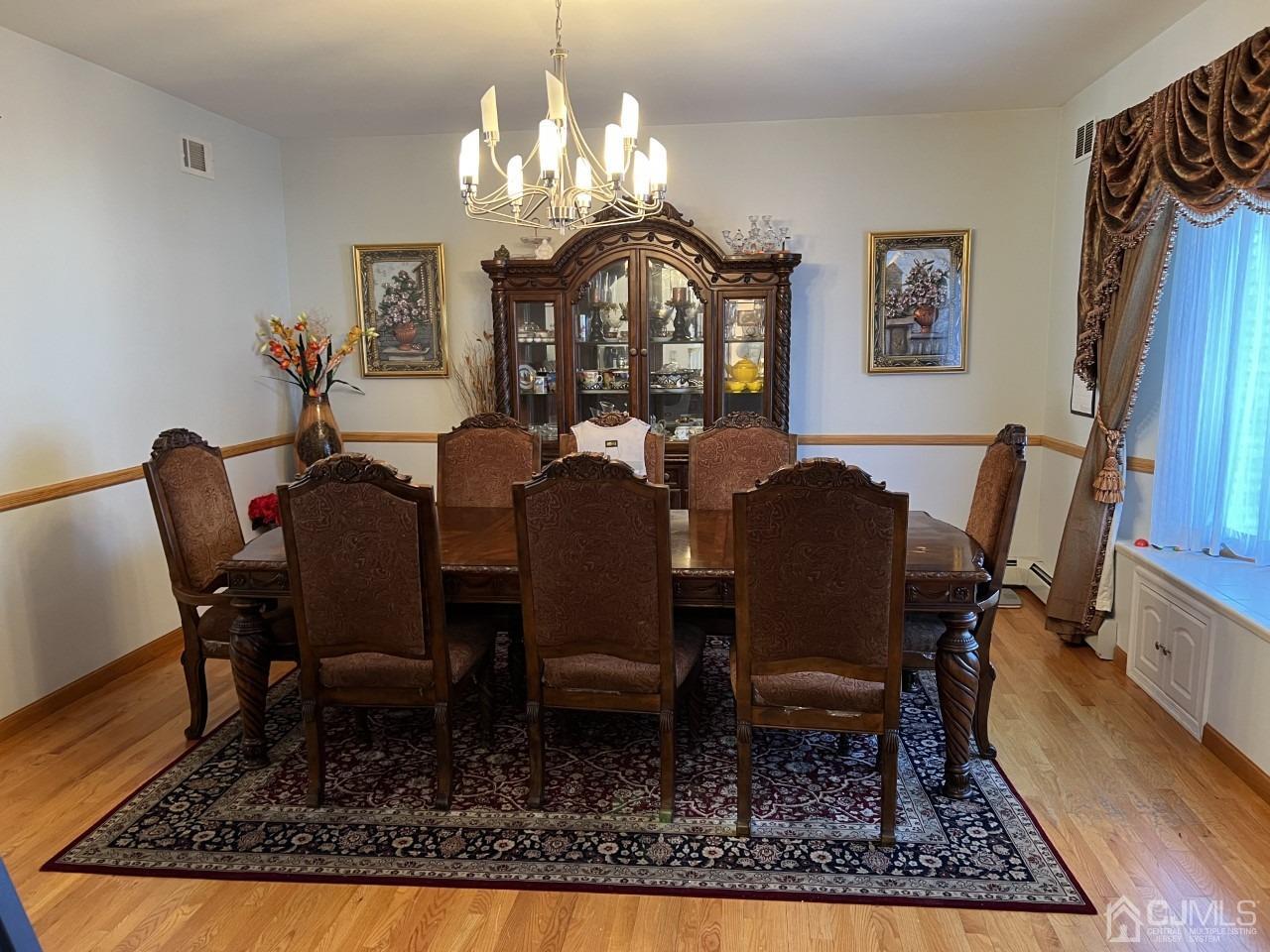 60 Utica Road Edison, NJ 08820 - Photo 6 of 38 a view of a dining room with furniture a rug and wooden floor
