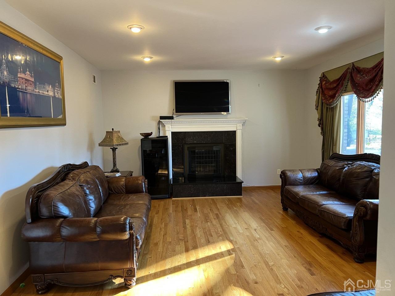 60 Utica Road Edison, NJ 08820 - Photo 8 of 38 a living room with furniture and a flat screen tv
