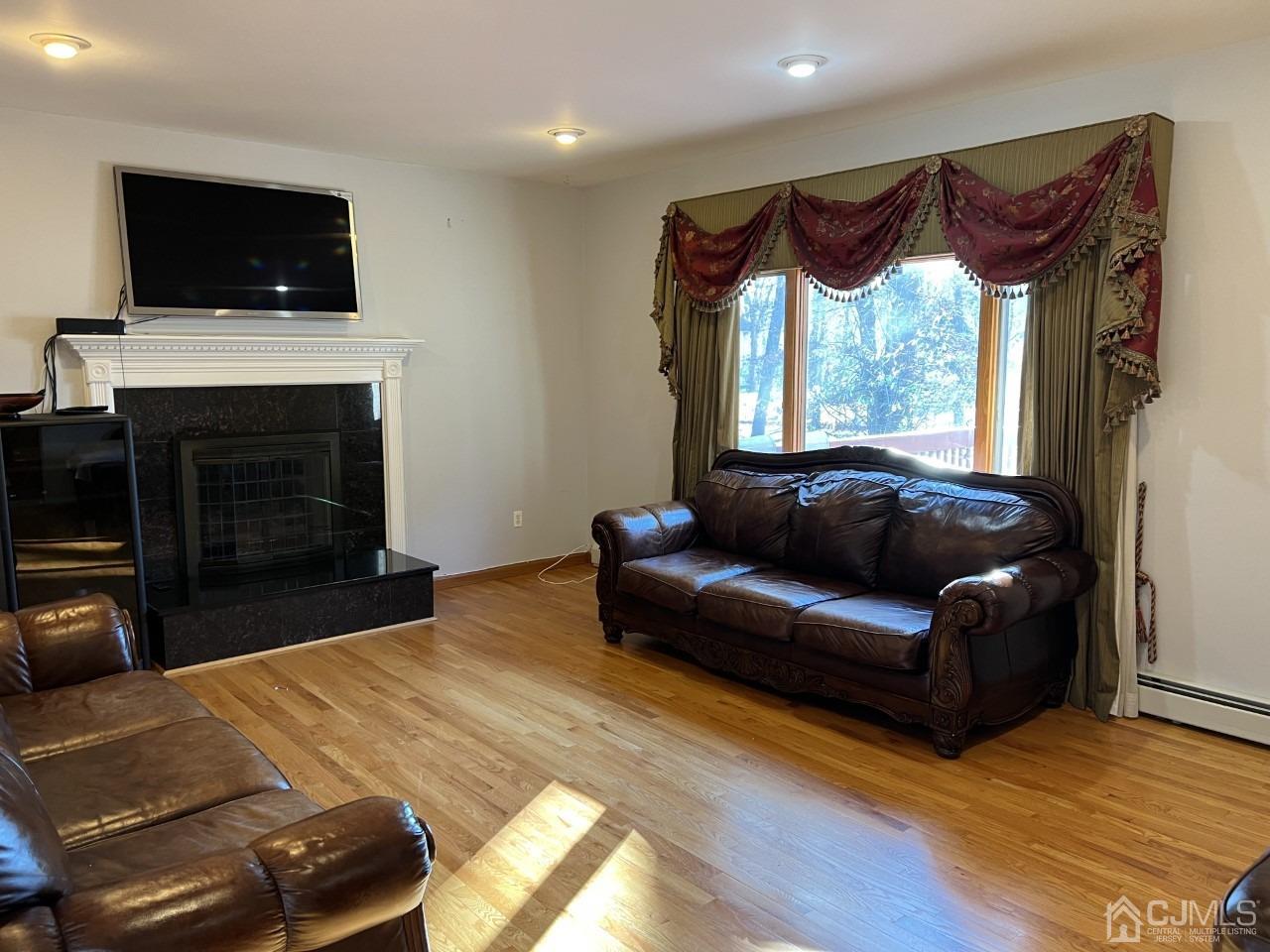 60 Utica Road Edison, NJ 08820 - Photo 9 of 38 a living room with furniture a fireplace and a flat screen tv