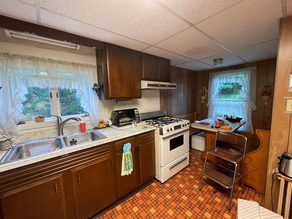 983 Lawsonham Road Rimersburg, PA 16248 - Photo 39 of 51 a kitchen with a stove a sink and a wooden cabinets