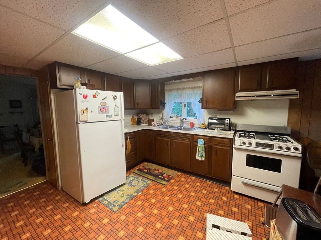 983 Lawsonham Road Rimersburg, PA 16248 - Photo 40 of 51 a kitchen with a refrigerator sink and wooden cabinets