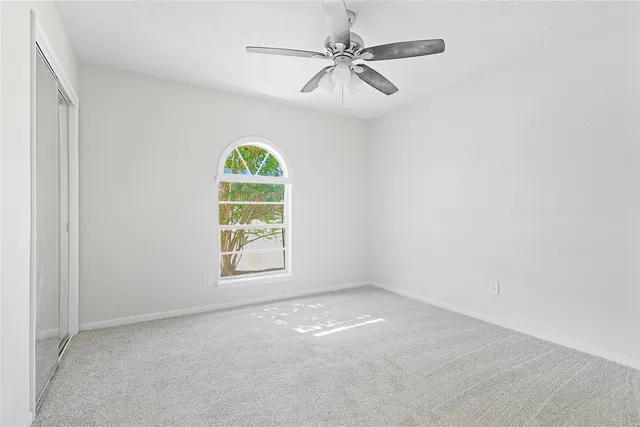 a bathroom with a double vanity sink a toilet a mirror and shower