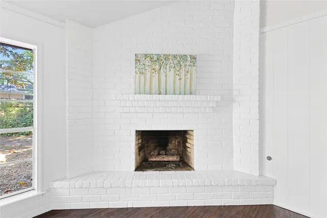 a living room with a fireplace and a window