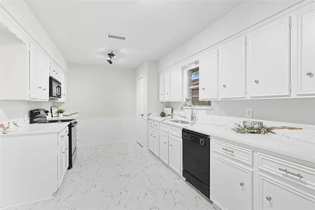 a kitchen with a sink stove and cabinets