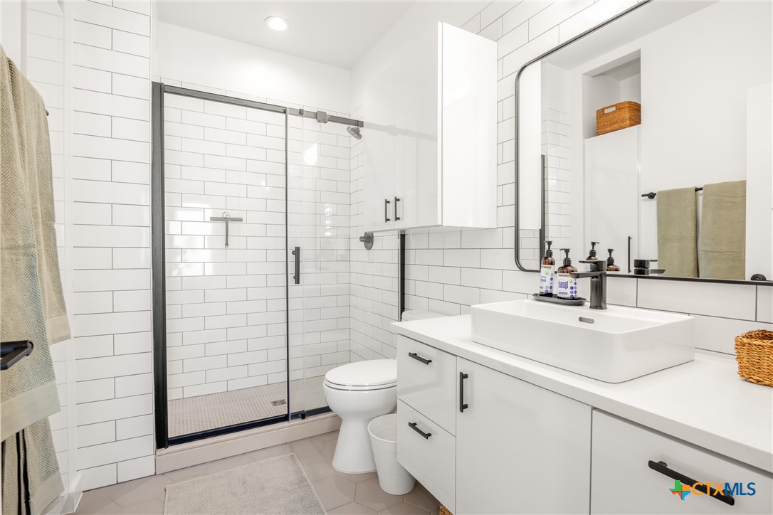 1909 Dutton Drive, Unit B San Marcos, TX 78666 - Photo 12 of 25 a bathroom with a sink toilet and shower
