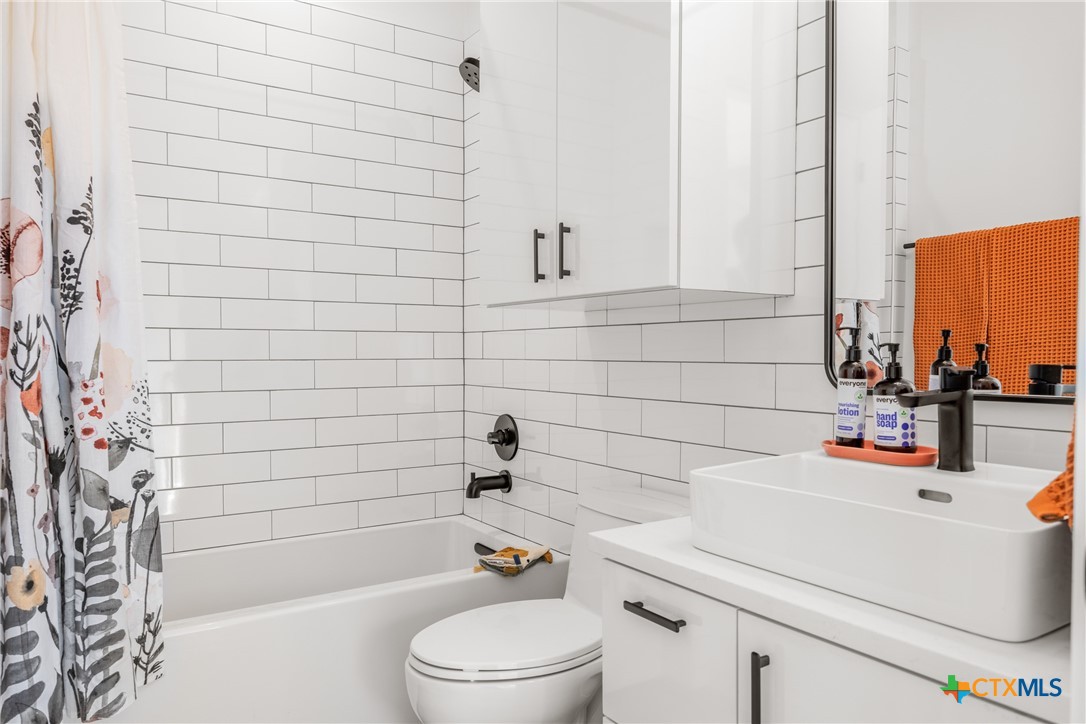 1909 Dutton Drive, Unit B San Marcos, TX 78666 - Photo 15 of 25 a bathroom with a sink a toilet and shower