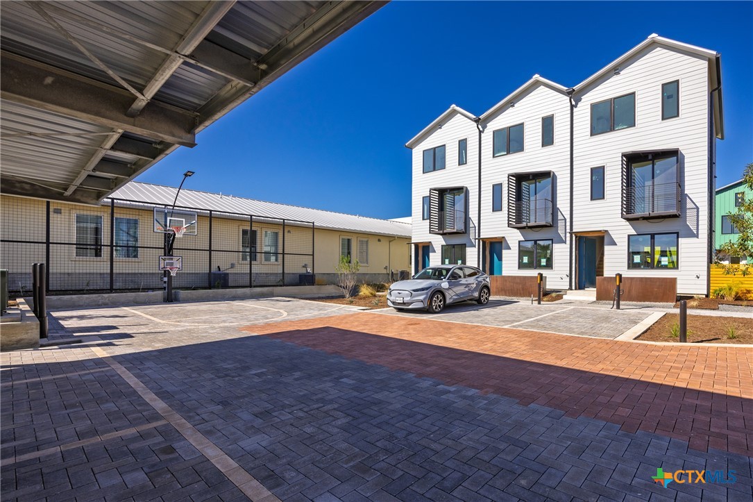 1909 Dutton Drive, Unit B San Marcos, TX 78666 - Photo 20 of 25 a front view of a building with street view