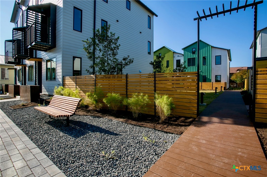 1909 Dutton Drive, Unit B San Marcos, TX 78666 - Photo 22 of 25 a front view of a house with a garden