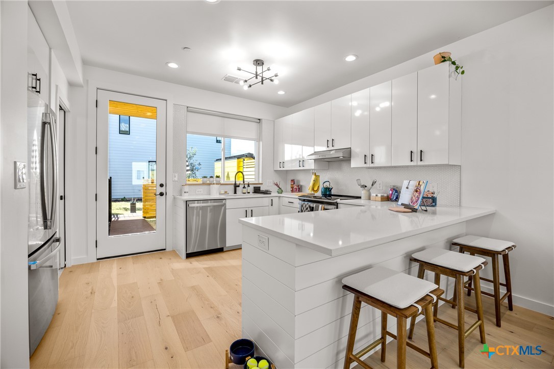 1909 Dutton Drive, Unit B San Marcos, TX 78666 - Photo 5 of 25 a kitchen with a sink cabinets and window